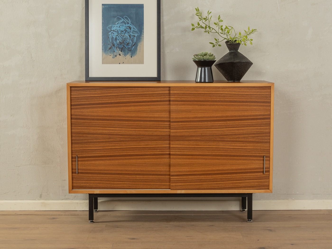 1950er Jahre Kommode aus Zebrano Furnier mit Edelstahlgriffen und schwarzen Vierkantstahlfüßen